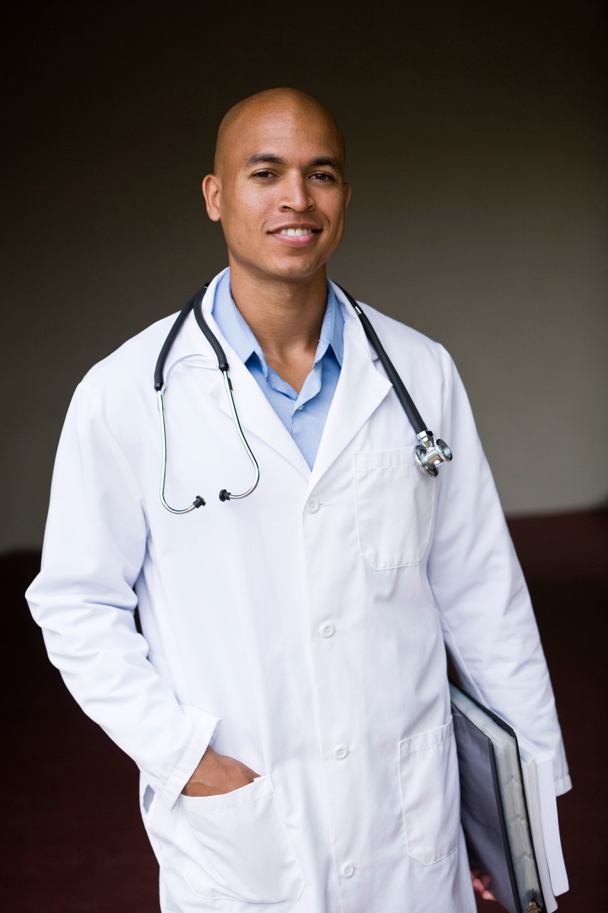 Young male doctor or medical student holding books